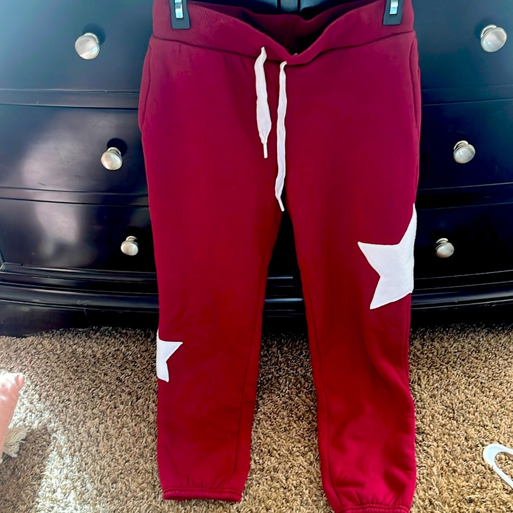 Maroon sweatpants, fleece lined with stars on the legs
